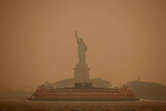 캐나다 산불을 타고 넘어온 연기로 미국 뉴욕시의 대기오염이 7일(현지시간) 전세계 최고 수준으로 악화됐다. 전날 뉴욕 자유의 여신상이 스모그로 뿌옇게 보이고 있다. 로이터뉴스1