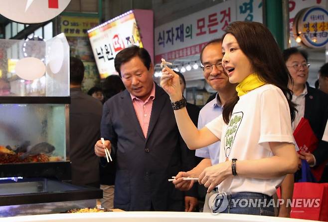 김건희 여사가 3일 오후 강원도 강릉시 중앙·성남시장을 방문해 횟집에서 오징어회를 시식하고 있다. 연합뉴스
