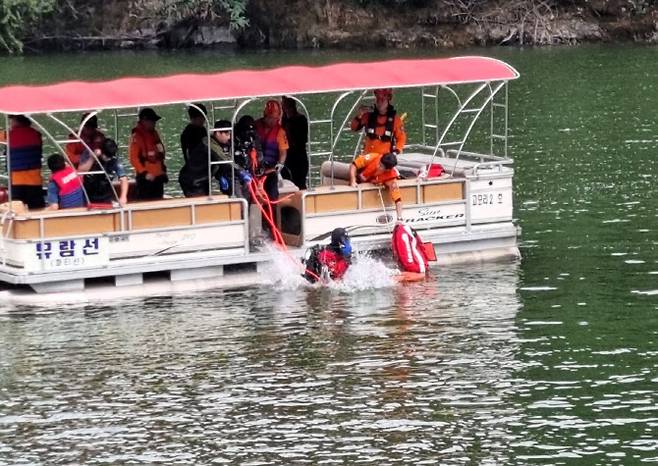 저수지에 빠진 헬리콥터의 탑승자 구조를 위해 잠수부가 물 속으로 들어가고 있다.(사진=경기도북부소방재난본부 제공)