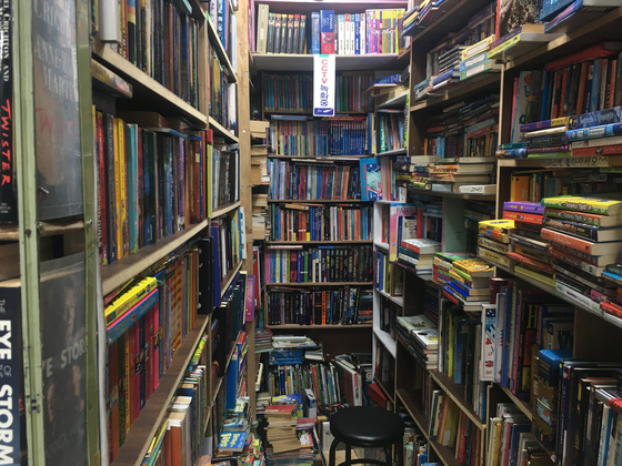 Bookshelves filled with used books line the walls inside Itaewon Books [LIM JEONG-WON]