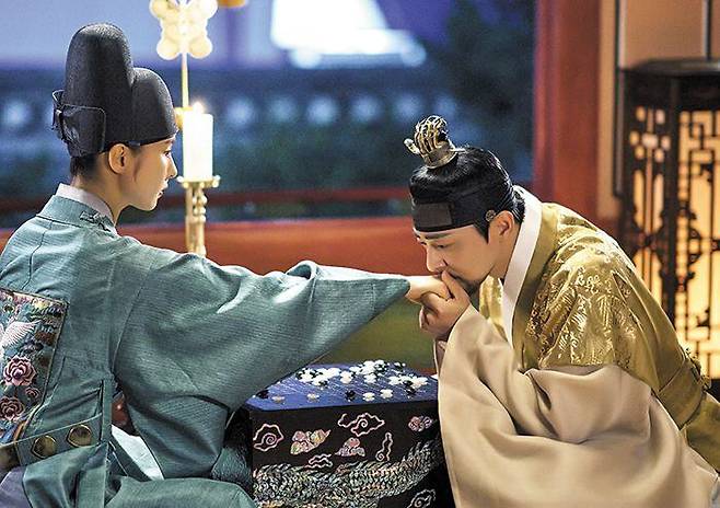 드라마 ‘세작, 매혹된 자들’에서 조선의 왕 이인(조정석·오른쪽)이 남장을 한 강희수(신세경)와 바둑을 두다 손등에 입을 맞추는 장면. 여성의 활동이 제약됐던 시대적 배경에서 나온 ‘남장 여자’ 서사는 해외에서 오히려 “신선하다”는 반응을 얻고 있다. /tvN