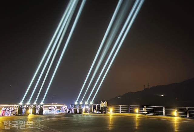 센츄리글로리호의 선상 파티가 열리는 도중 대형 레이저 불빛이 하늘을 비추고 있다.