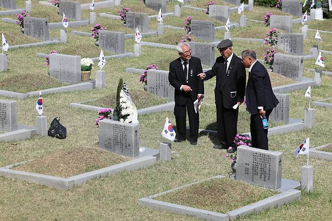 한국학생운동자협의회 회원들이 동료의 묘에 참배한 뒤 대화하고 있다. 김영원 기자