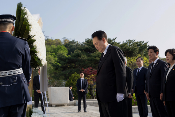 President Yoon Suk Yeol pays tribute at the April 19th National Cemetery in Gangbuk District, northern Seoul, on Friday. [PRESIDENTIAL OFFICE]
