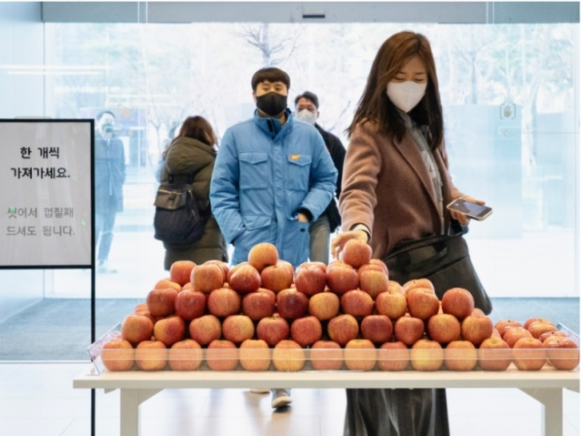 지난해 애플페이 한국 상륙 당시 현대카드 직원들이 ‘애플 페이 서비스’를 자축하기 위해 마련한 사과를 가져가는 모습. [사진, 현대카드]