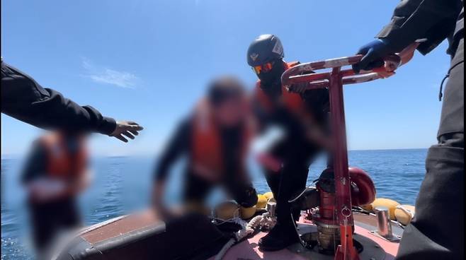 전복된 모터 보트에 탔던 승선원이 구조되는 모습 (사진, 제주해양경찰서)