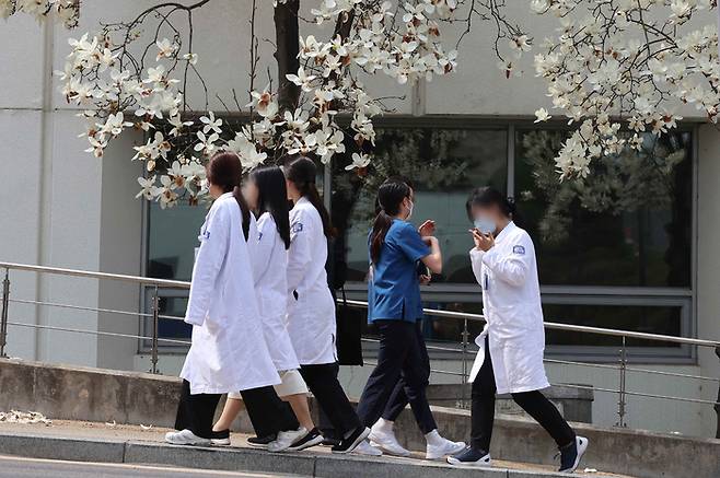 ‘병원에도 곧 봄이 올까요?’  서울 시내 한 대형병원에서 의료진이 목련이 핀 나무를 지나 이동하고 있다. 연합뉴스