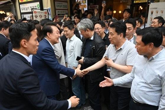 취임 2주년을 맞은 윤석열 대통령이 10일 서울 중구 다동 음식문화거리를 방문해 시민들과 인사를 나누고 있다. 대통령실통신사진기자단