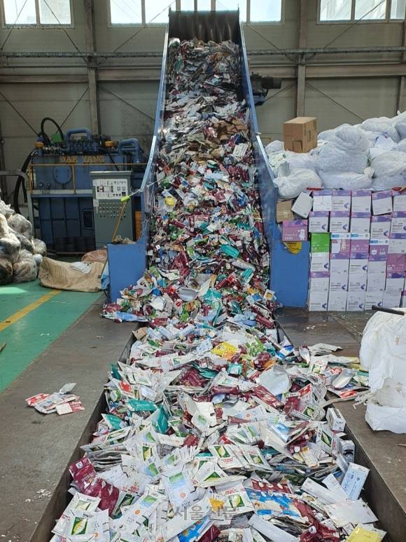 일차적으로 플라스틱이나 캔, 이물질 등과 구분해 선별한 종이팩 쓰레기는 컨베이어 벨트 위에서 한번 더 분류된다. 부산 김예슬 기자