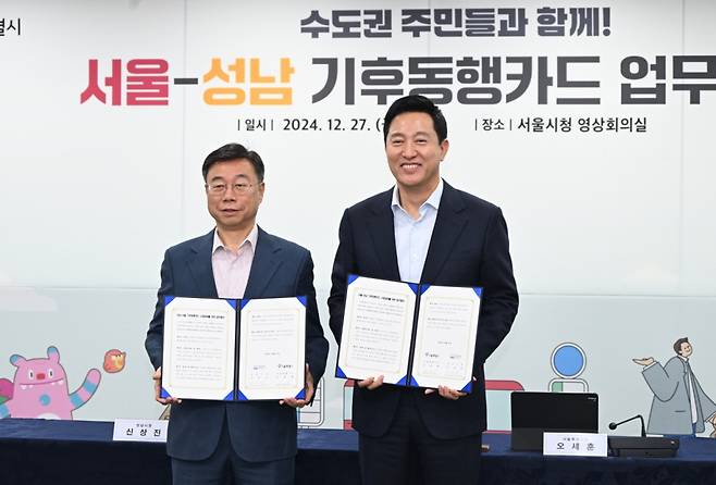오세훈 서울시장(사진 오른쪽)과 신상진 성남시장이 27일 기후동행카드 업무협약 체결 후 협약서를 들고 기념촬영하고 있다./사진=서울시