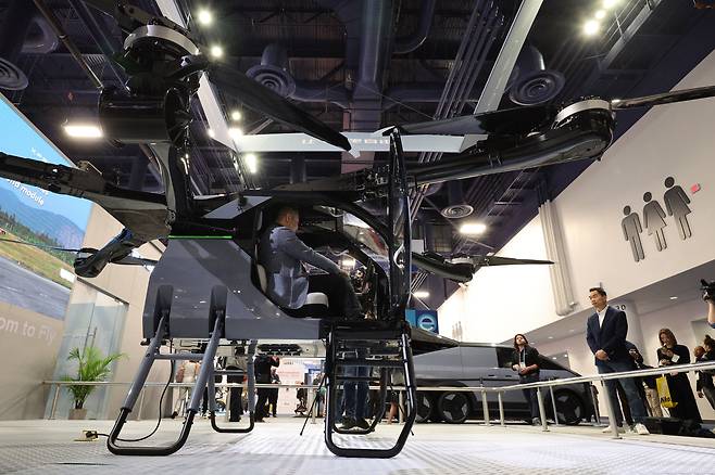 세계 최대 정보기술(IT)·가전 전시회 'CES 2025' 개막일인 7일(현지시각) 미국 네바다주 라스베이거스 컨벤션센터(LVCC)에 중국 전기차 업체 샤오펑 부스에서 관람객들이 모듈식 비행 자동차(플라잉카)를 살펴보고 있다. /뉴스1