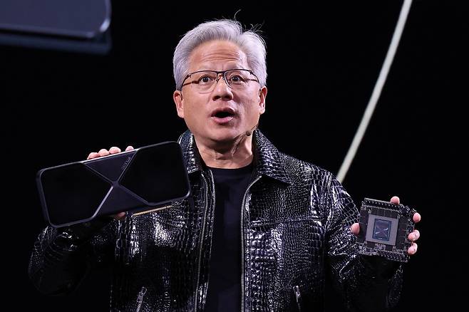 젠슨 황 엔비디아 최고경영자(CEO)가 세계 최대 IT(정보기술)·가전 전시회 'CES 2025' 개막을 하루 앞둔 지난 6일(현지시간) 미국 네바다주 라스베이거스 만달레이베이 컨벤션센터에서 가진 기조연설에서 최신 인공지능(AI) 가속기 '블랙웰'(Blackwell)을 탑재한 지포스 RTX 50 시리즈 그래픽 카드를 공개하고 있다./사진=라스베이거스(미국)=뉴스1