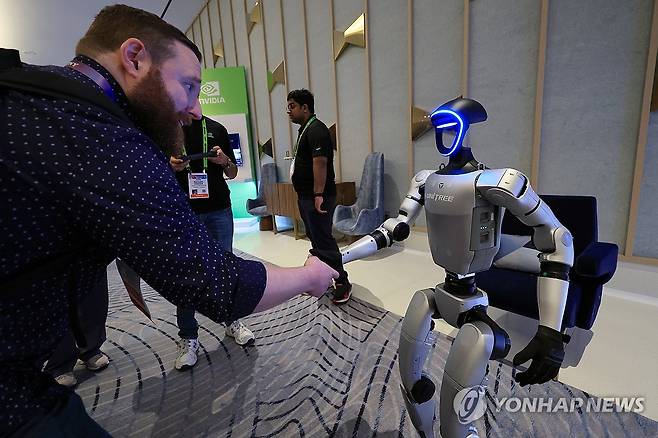 악수하는 유니트리 G1 (라스베이거스=연합뉴스) 신현우 기자 = 세계 최대 가전·정보기술(IT) 전시회 CES 2025 개막인 7일 오전(현지시간) 젠슨 황 엔비디아 최고경영자(CEO) 글로벌 기자간담회가 열린 미국 네바다주 라스베이거스 퐁텐블루 호텔 엔비디아 전시관에서 휴머노이드 로봇 유니트리 G1이 관람객과 악수하고 있다. 2025.1.8 nowwego@yna.co.kr