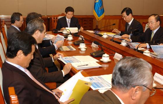 노무현 대통령이 2005년 3월 23일 오후 청와대에서 열린 신용불량자 대책회의에서 신용회복지지원 방안에 대한 보고서를 읽고 있다. 청와대사진기자단