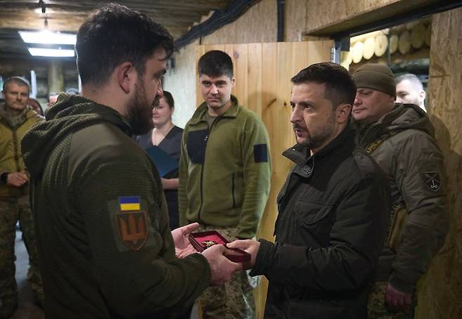 우크라이나의 볼로디미르 젤렌스키 대통령(오른쪽)이 지난해 12월 12일 남부 자포리자주 전선을 방문해 야전 군의관에게 훈장을 수여하고 있다.AFP연합뉴스