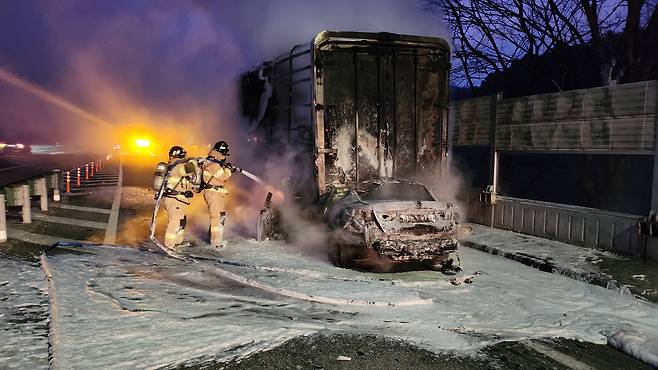 26일 오전 강원 원주시 문막읍 영동고속도로 강릉방면의 한 졸음쉼터에서 주차된 25t 트럭을 K5승용차가 들이받아 화재가 발생, 소방대원들이 진화작업을 벌이고 있다. /강원소방본부