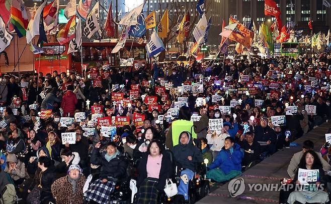 윤 대통령 파면 촉구 집회 (서울=연합뉴스) 김인철 기자 = 12일 서울 종로구 광화문 동십자각 앞에서 윤석열 즉각퇴진·사회대개혁 비상행동 주최로 열린 윤 대통령 즉각파면 매일 긴급집회에서 참가자들이 구호를 외치고 있다. 2025.3.12 yatoya@yna.co.kr
