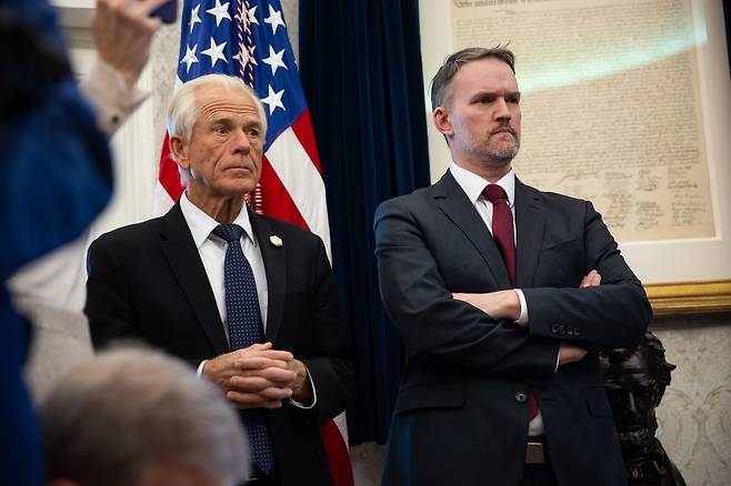 White House Senior Counselor for Trade and Manufacturing Peter Navarro (left) and US Trade Representative Jamieson Greer look on as US President Donald Trump delivers remarks on auto tariffs and other topics in the Oval Office at the White House on Wednesday. (Pool Photo via EPA)