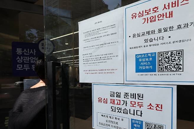 30일 서울 시내 한 SK텔레콤 인증 대리점에 유심 재고 소진과 유심보호 서비스 가입 안내문이 동시에 붙어있다. 연합뉴스