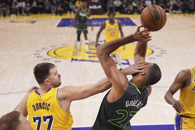 <yonhap photo-3180=""> Minnesota Timberwolves center Rudy Gobert, right, is hit in the face by Los Angeles Lakers guard Luka Doncic as he grabs a rebound during the first half in Game 5 of an NBA basketball first-round playoff series Wednesday, April 30, 2025, in Los Angeles. (AP Photo/Mark J. Terrill)/2025-05-01 12:41:30/ <저작권자 ⓒ 1980-2025 ㈜연합뉴스. 무단 전재 재배포 금지, AI 학습 및 활용 금지></yonhap>