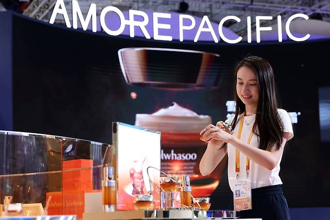 A woman tries out skin care products at the Amorepacific booth during the 7th China International Import Expo in Shanghai on Nov. 5, 2024. (Getty Images)