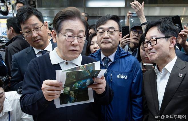 (단양=뉴스1) 이재명 기자 = '골목골목 경청투어 : 단양팔경편'에 나선 이재명 더불어민주당 대통령 후보가 4일 오전 충북 단양군 단양구경시장에서 상인이 건네 준 편지를 읽어보고 있다. 2025.5.4/뉴스1 Copyright (C) 뉴스1. All rights reserved. 무단 전재 및 재배포, AI학습 이용 금지. /사진=(단양=뉴스1) 이재명 기자