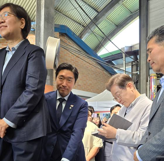 이재명 민주당 대선 후보가 유세 중 무대 뒤에서 지지자에게 사인해주는 모습. 강보현 기자