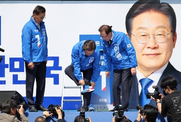 더불어민주당 이재명 대선 후보가 12일 오전 서울 청계광장에서 열린 출정식 및 첫 유세에서 운동화를 갈아 신고 있다. 2025.5.12 홍윤기 기자