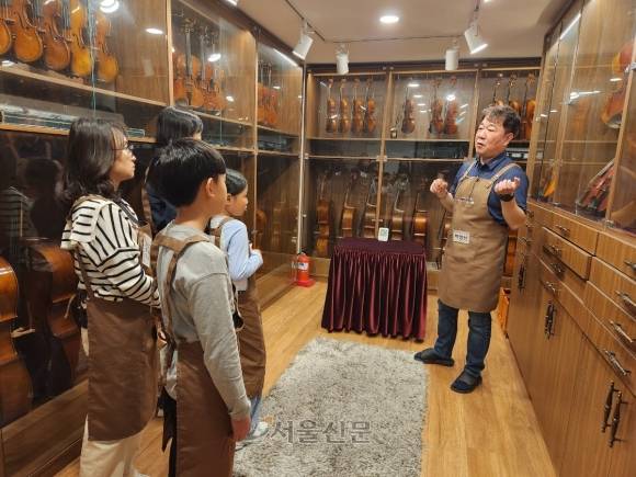 지난달 26일 서울 서초구의 한 현악기 공방에서 서초문화재단의 ‘클래식악기 탐구생활’ 수업이 진행되고 있다. 학부모와 학생이 2인 1조를 이뤄 프로그램에 참여한다.