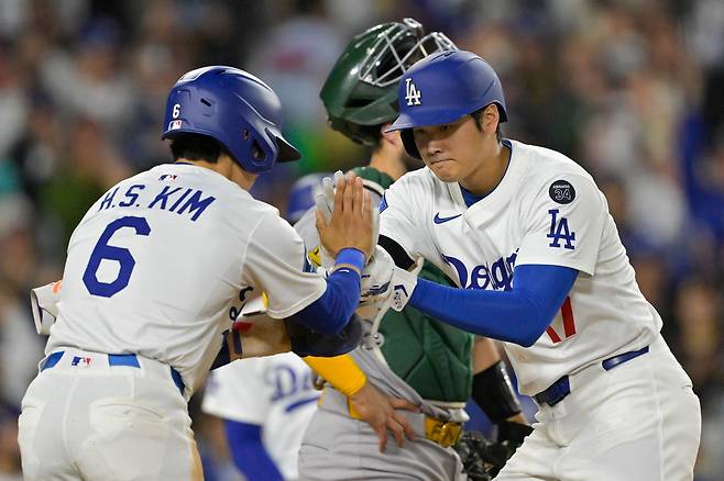 LA 다저스 김혜성이 16일 애슬레틱스전에서 4회말 오타니의 홈런으로 홈을 밟은 뒤 오타니와 하이파이브를 하고 있다. Imagn Images연합뉴스