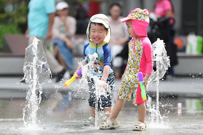 여름 기운이 돌기 시작하는 절기 ‘소만’인 21일 무더운 날씨가 이어진 가운데 서울 종로구 광화문 광장에서 아이들이 물장구를 치며 더위를 식히고 있다. /장경식 기자