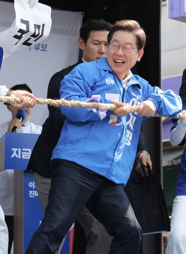 이재명 더불어민주당 대선 후보가 25일 충남 당진시 당진전통시장에서 연설에 앞서 줄다리기 퍼포먼스를 하고 있다. 당진=오승현 기자 2025.05.25