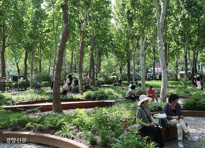 지난 22일 서울 동작구 보라매공원에서 열린 ‘2025서울국제정원박람회’를 찾은 시민들이 버즘나무를 활용한 작가정원에서 휴식을 즐기고 있다. 정지윤 선임기자