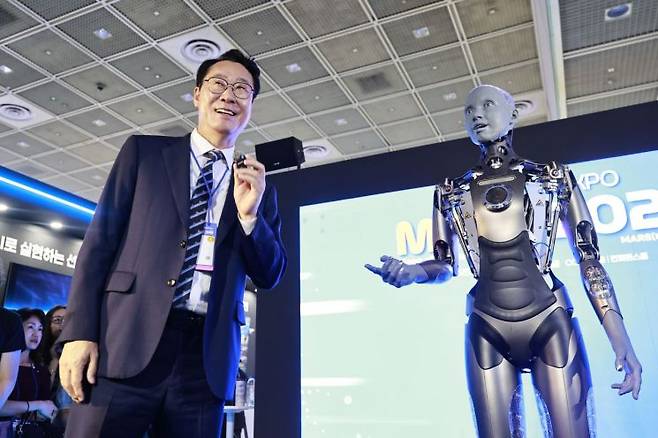 서울 삼성동 코엑스에서 18일 개막한 화성시의 AI 박람회 'MARS 2025'에서 정명근 화성시장이 휴머노이드 로봇 '아메카'와 대화하고 있다. 화성시 제공