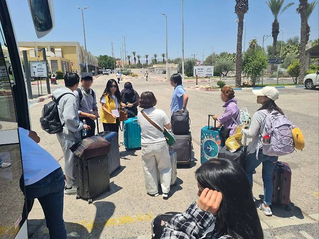 이스라엘 집결지에서 임차 버스를 타기 위해 이동중인 우리 국민들.(외교부 제공)
