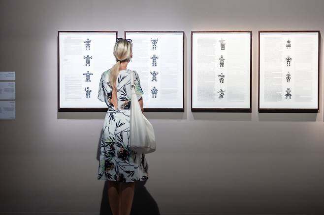 A visitor views "Evolution Revolution Resolution" by Paik Nam-june, on display at the exhibition "Layered Mediums: We Are in Open Circuits," running at Manarat Al Saadiyat in Abu Dhabi, UAE. (ADMAF