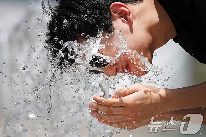 밤낮없이 폭염의 기세가 이어진 1일 오후 대구 수성구 수성패밀리파크에서 한 시민이 얼굴에 물을 끼얹으며 열기를 식히고 있다. 2025.7.1/뉴스1 ⓒ News1 공정식 기자