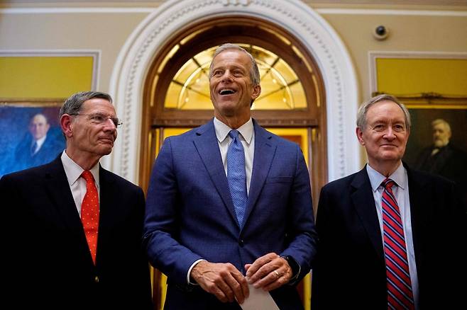 존 슌 미국 공화당 상원 원내대표(가운데)가 존 바라소 의원(와이오밍, 왼쪽)과 마이크 크레이포 의원(인디애나, 오른쪽)과 함께 1일(현지시간) 상원에서 트럼프 대통령의 '숙원'인 '크고 아름다운 하나의 법안(OBBBA)'이 통과된 후 의회의사당에서 기자들에게 관련 내용을 설명하고 있다. / 사진=AFP