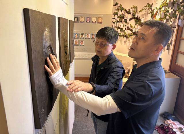 서민택(오른쪽) 삼성교회 목사가 조지 존스 선교사 얼굴 모형을 손끝으로 느끼는 장면.