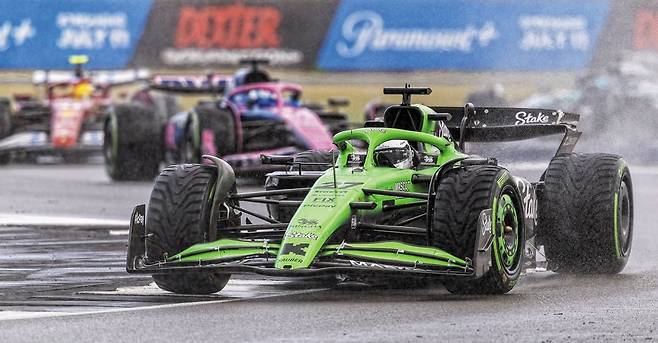 영화 ‘F1 더 무비’ 같은 일이 실제로 일어났다. 6일(현지 시각) 열린 F1 영국 그랑프리에서 하위권 팀 킥 자우버 소속의 니코 휠켄베르크가 3위를 차지하는 이변을 연출했다. 휠켄베르크가 차량에 빗길용 타이어를 장착하고 서킷을 질주하고 있다./게티이미지코리아