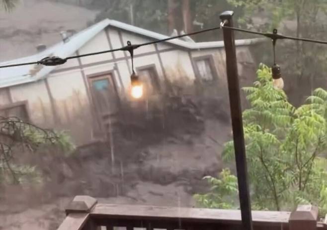 8일 뉴멕시코주 루이도소에서 촬영된 영상에서 한 주택이 급류에 휩쓸려 떠내려가고 있다. AP뉴스가 관련 영상을 갈무리한 사진이다. AP연합뉴스