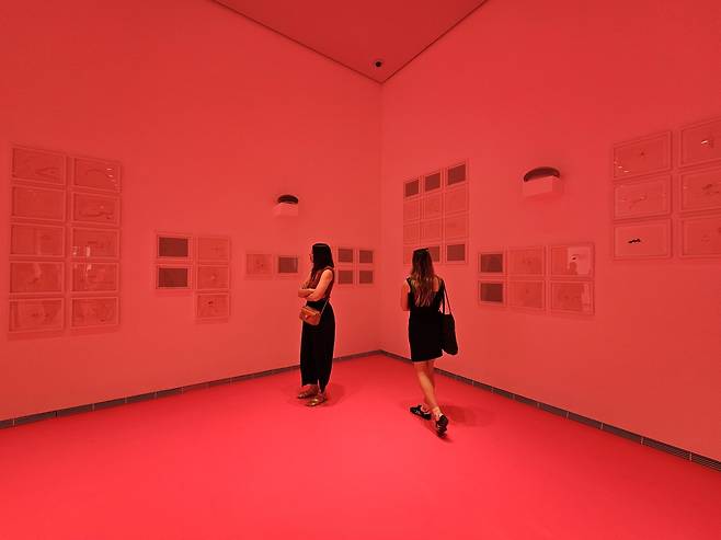 Visitors look around the exhibition "Land of Ousss (Kangse)" at LUMA Arles in Arles, France, Saturday. (Park Yuna/The Korea Herald)