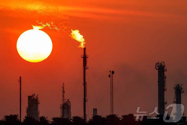 2024년 12월 22일(현지시간) 이라크 바그다드에 위치한 도라 정유단지 뒤로 해가 지고 있다. (사진은 기사 내용과 무관함) 2024.12.22. ⓒ AFP=뉴스1 ⓒ News1 윤다정 기자