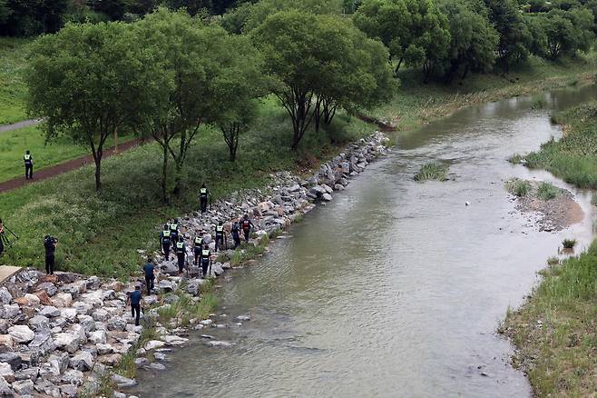 지난 18일 오후 세종시 나성동 제천변에서 경찰이 물에 휩쓸려 실종된 40대 남성을 수색하고 있다. A씨는 17일 오전 1시 50분께 이 근처에서 언덕을 내려가다가 불어난 천변 물에 휩쓸렸다./연합뉴스
