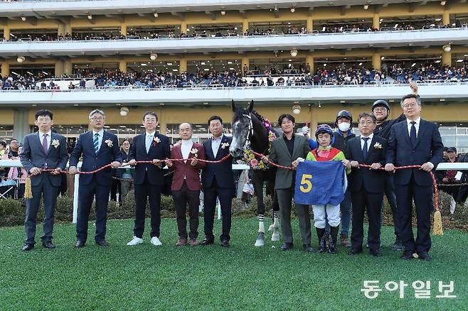 지난해 열린 동아일보배 대상경주에서 우승한 즐거운여정과 김영관 조교사(왼쪽에서 5번째). 김 조교사 왼쪽은 선경래 마주. 동아일보 DB