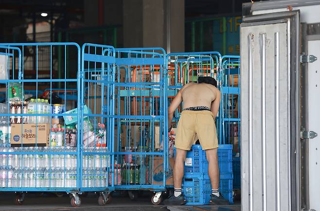 전국 대부분 지역에 폭염 특보가 발효된 지난 7월 10일 서울의 한 물류센터에서 직원이 상의를 벗고 상차 작업을 하고 있다. 연합뉴스