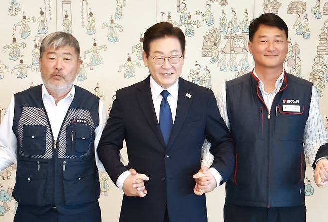 취임 후 첫 만남 - 이재명 대통령이 4일 서울 용산 대통령실에서 열린 양대 노총 위원장과의 오찬 간담회에서 김동명(왼쪽) 한국노총 위원장, 양경수 민주노총 위원장과 나란히 손을 잡고 웃으며 기념촬영을 하고 있다. 대통령이 양대 노총 위원장을 만난 건 5년 6개월 만이다. 연합뉴스