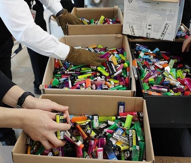 서울 강서구 김포공항 국내선 여객터미널에서 보안검색요원들이 올해 수거된 라이터들을 상자에 담고 있다. 라이터는 기내에 1인당 1개 반입 가능하나 2개 이상 소지로 보안검색 과정에서 적발되는 라이터 수량은 연간 44만개, 올해 들어 수거된 라이터 수량은 8600개라고 한국공항공사는 밝혔다. 2024.1.26. 연합뉴스