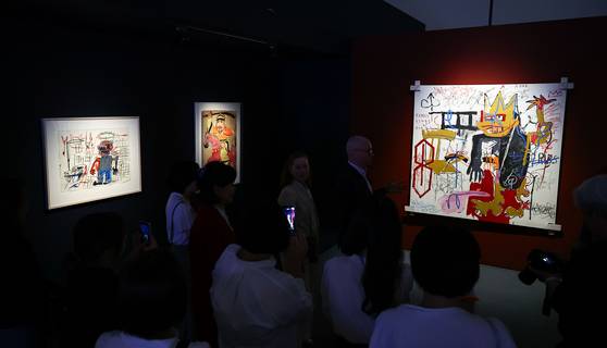 서울 동대문디자인플라자(DDP) 전시1관에서 22일 선공개된 ‘장 미셸 바스키아: 과거와 미래를 잇는 상징적 기호들' 전시장에 바스키아의 '전사'(맨 왼쪽), 민화 최영 장군, 바스키아의 '왕이라 불린 에이원(A-One)'이 나란히 걸려 있다. 김종호 기자