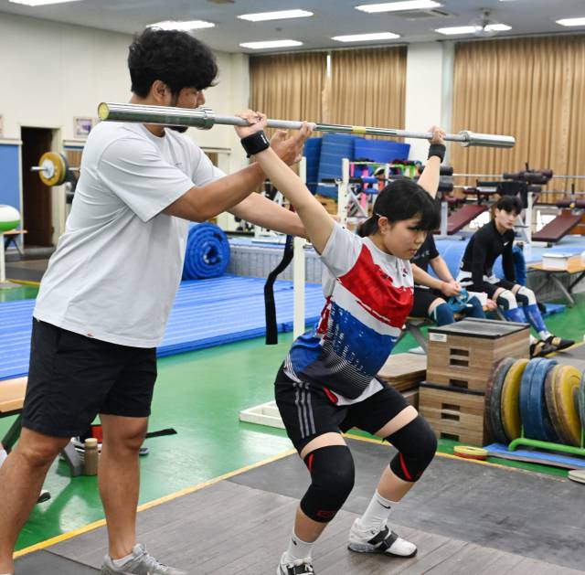 경남체고 역도부 조익래 지도자가 박서현의 자세를 교정하고 있다.